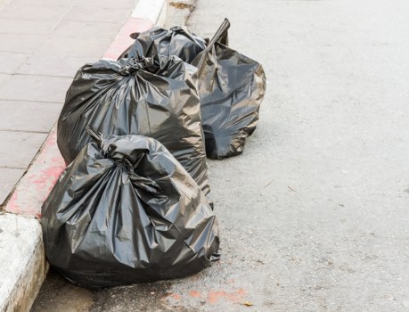 Professionals loading waste into a skip container